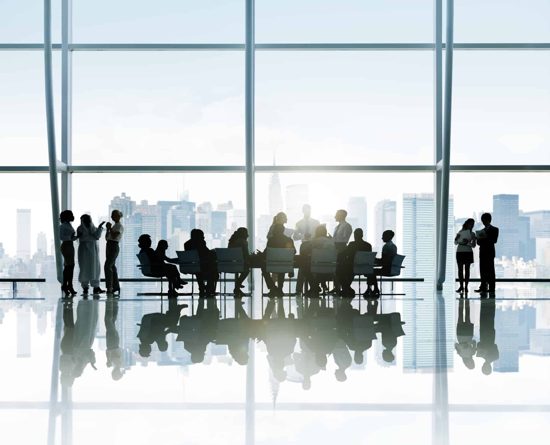 Silhouettes Of Business People Around The Conference Table With